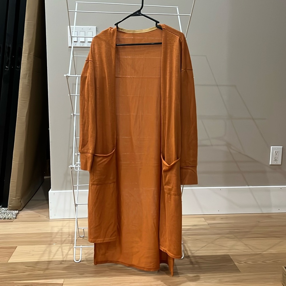 Lightly warn orange cardigan with pockets